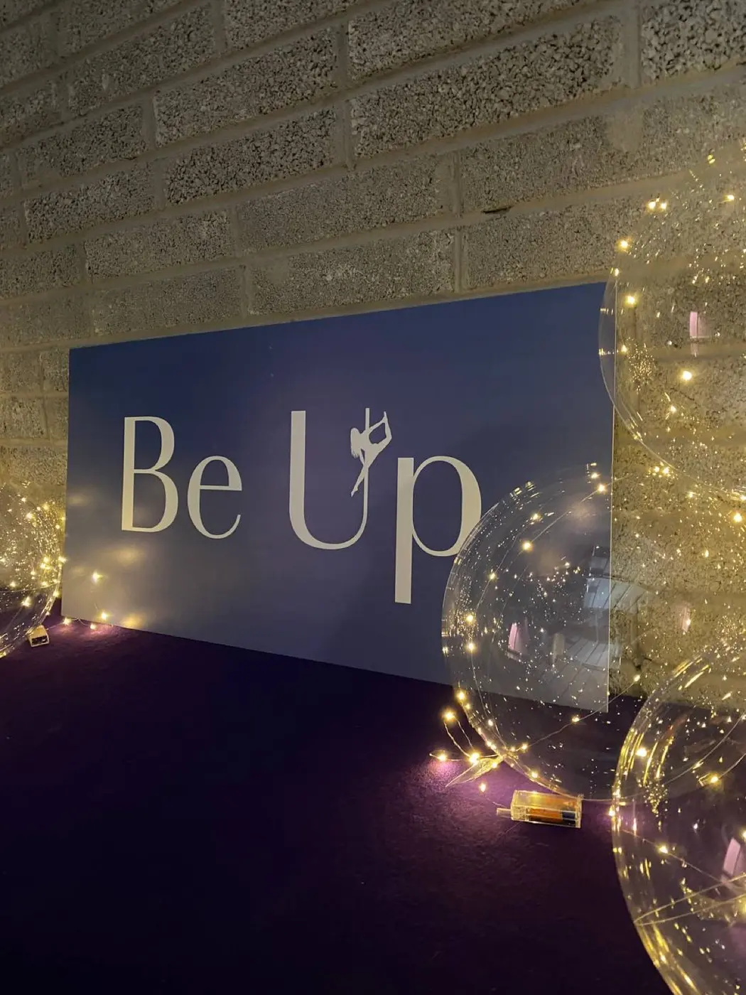 The Be Up sign in the studio, with fairy-light balloons